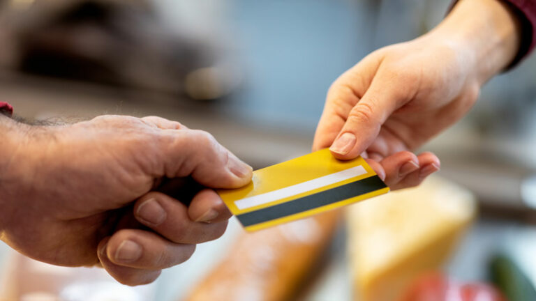 Customer exchanging a card with a cashier